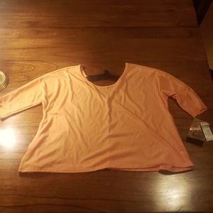 Melon orange blouse with black strap across V back. NWT
